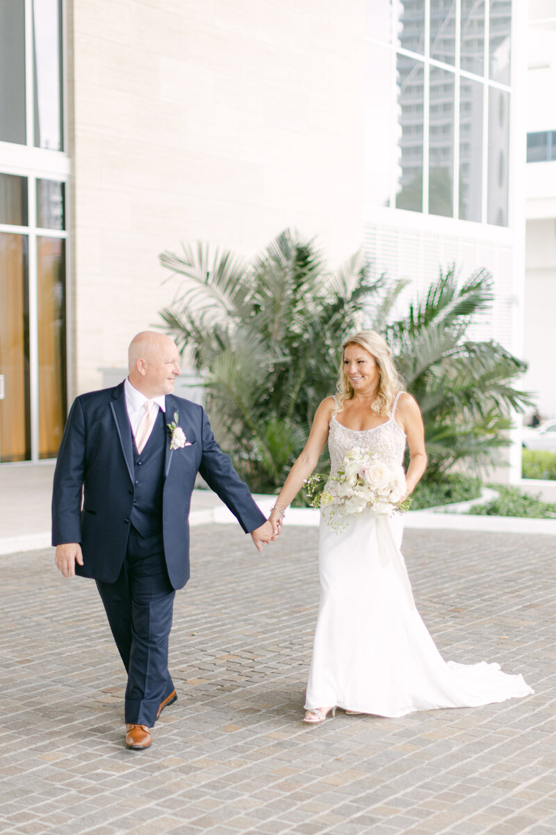 Renee and Ken walk holding hands.