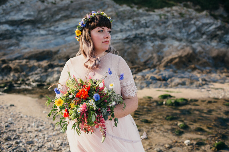 Bride in pink wedding dress at the beach in Cornwall