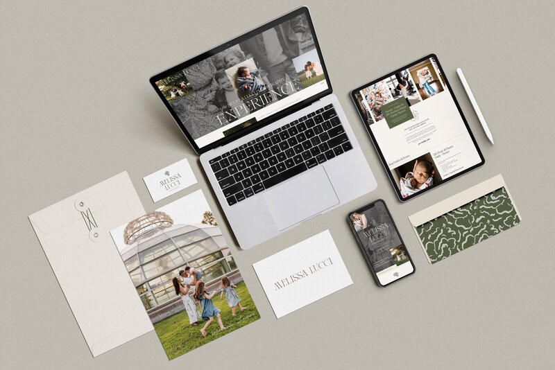 A laptop, tablet, smartphone, business cards, envelopes, and brochures displaying consistent branding and family photos are arranged on a neutral background, showcasing comprehensive brand identity design services.