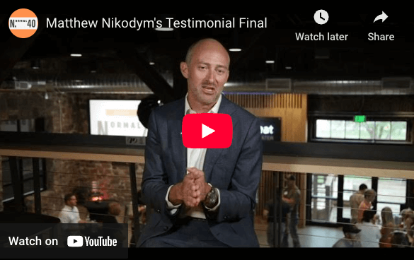 Matthew Nikodym sharing his Vintage One testimonial on video at a Normal 40 in-person mastermind event