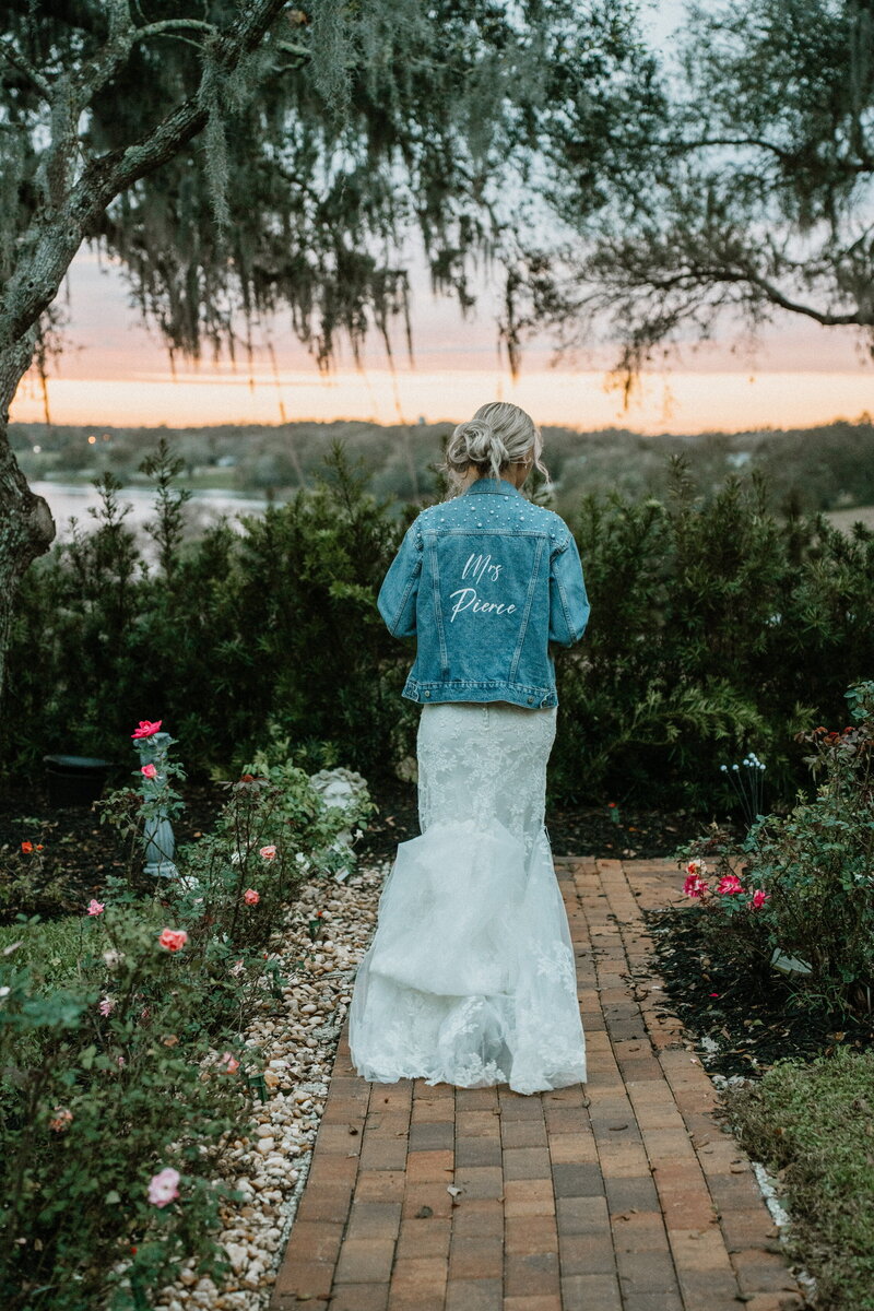 Bride walking through the garden paths at Lakeview Gardens in Umatilla, surrounded by blooming greenery.