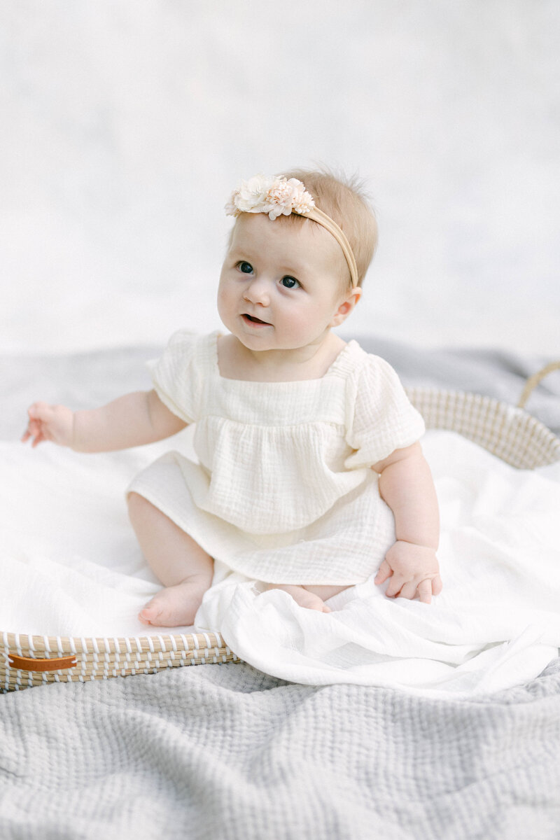 little 6 month old sitting in basket smiling knoxville tennessee newborn photographer