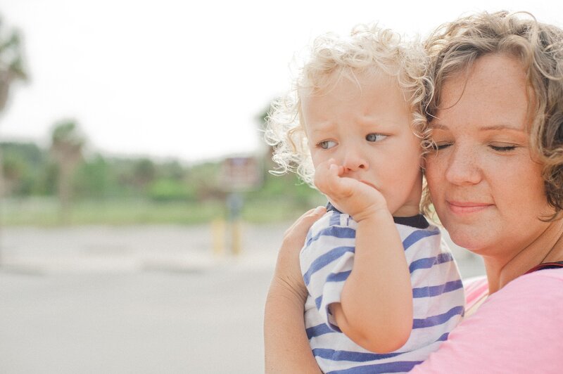 Priscilla Baierlein, photographer, snuggling blonde curly haired son in Clearwater FL.