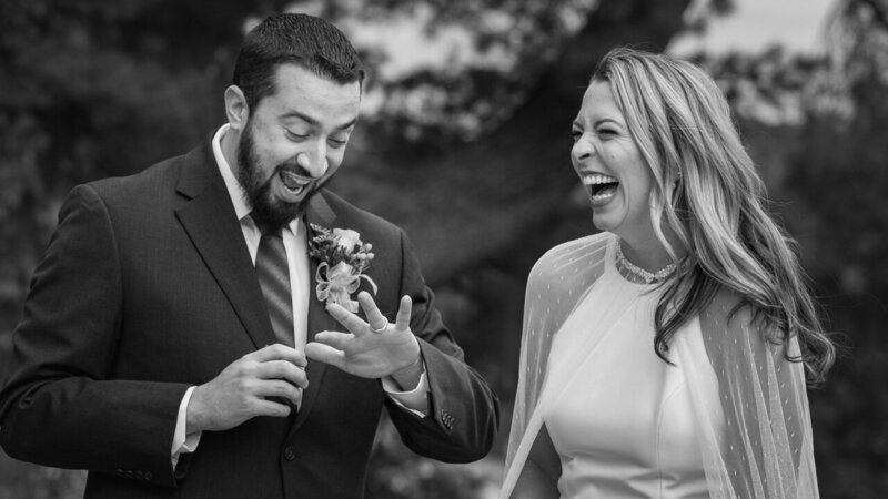 Groom looking at his wedding ring in happy shock, a candid and emotional moment captured in photojournalistic style.