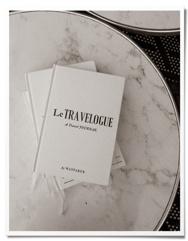 Embossed cream luxury linen travel journal on marble table in Paris
