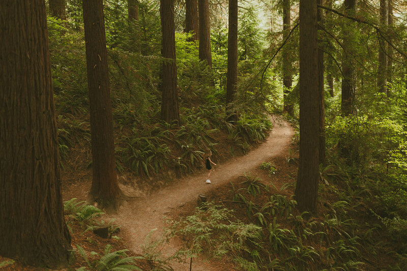 girl standing in forest in portland nature park