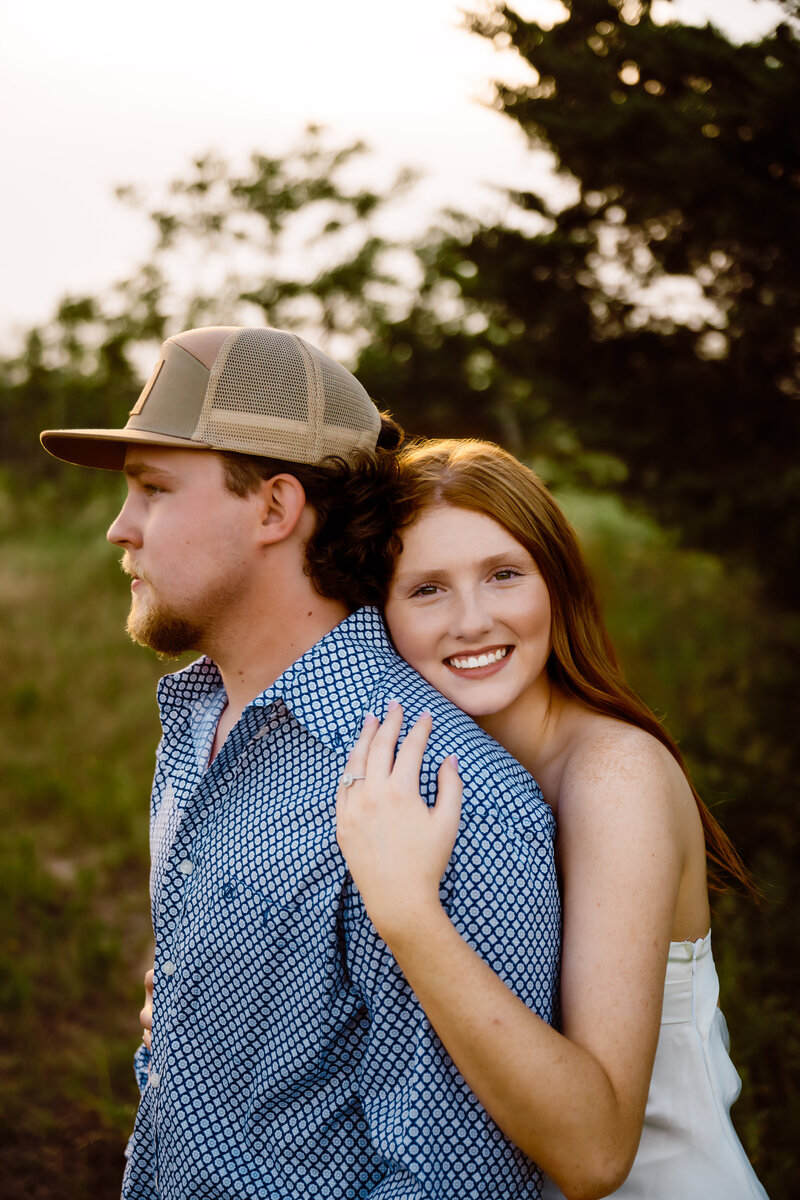 a bride tip hers husbands cowboy hat to sneak a kiss during golden hour photos with Shelly Voss Photography