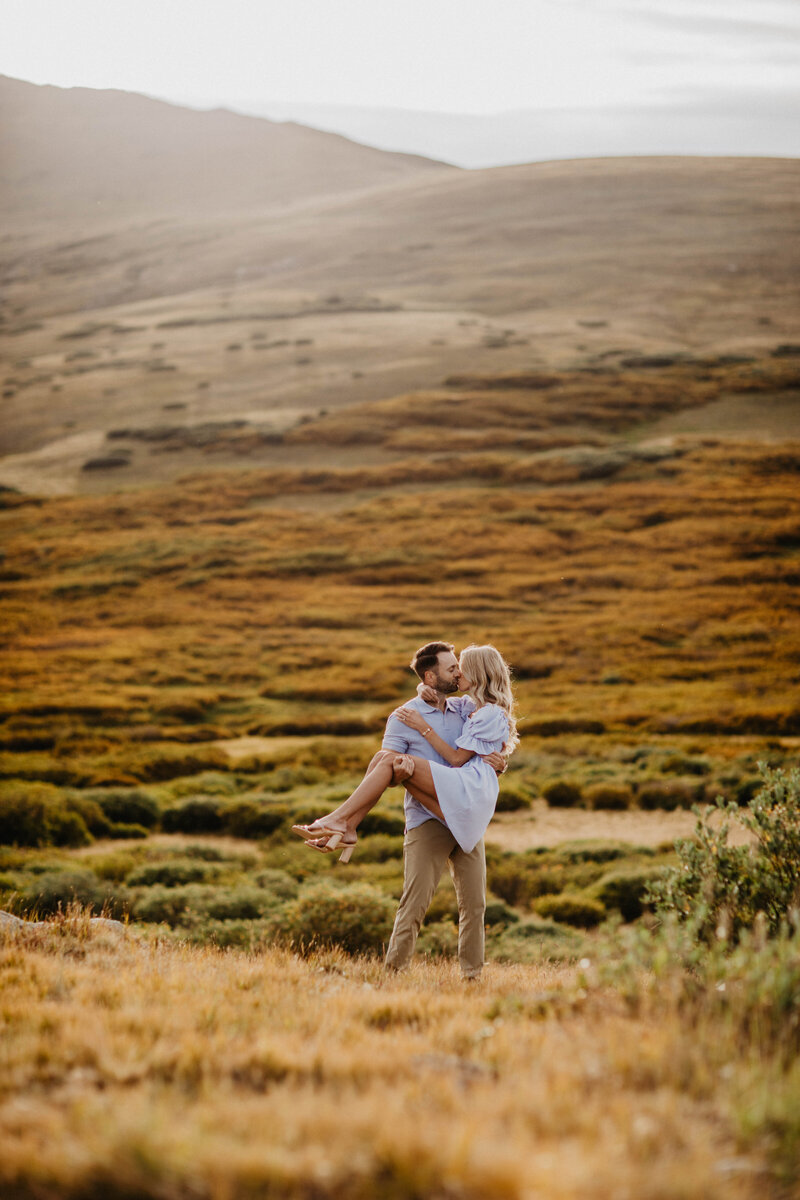 man and woman standing with their backs to each other next to large marble pillars