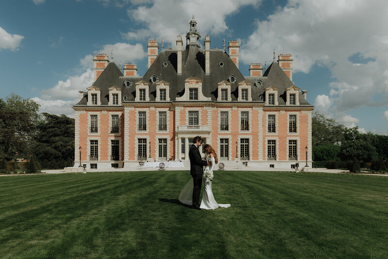 bride and groom laugh in black tie