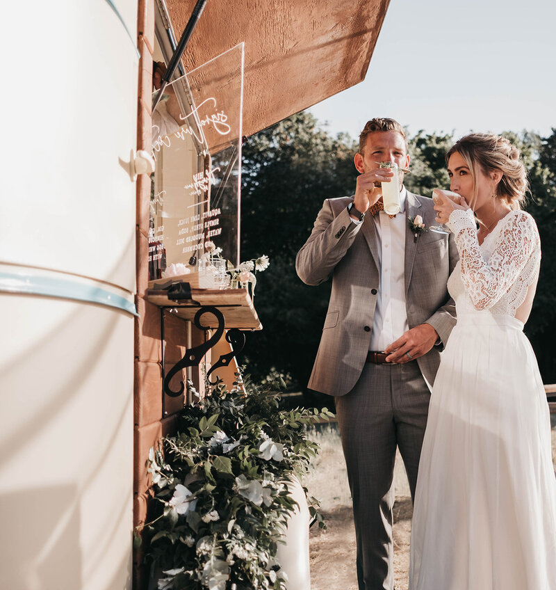 bride and grooming sipping on a cocktail