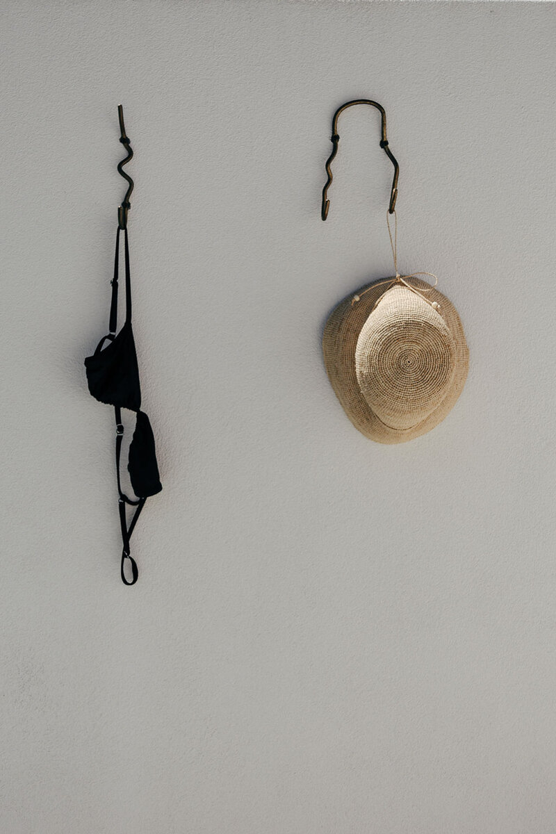 Bikini and hat hanging from the wall