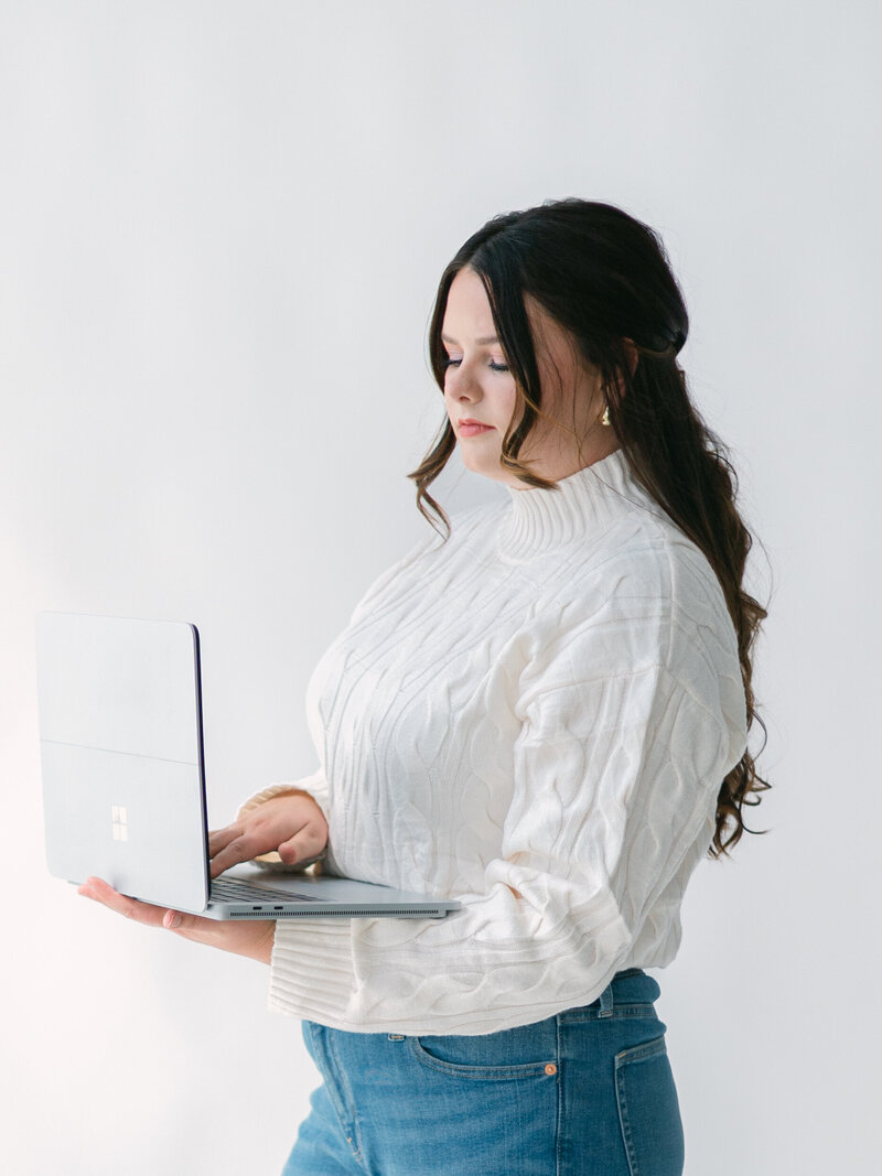 woman smiling while holding camera