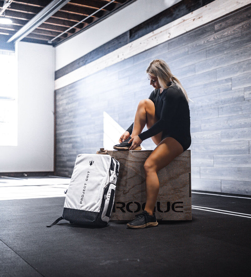 Image of personal fitness trainer sitting on road