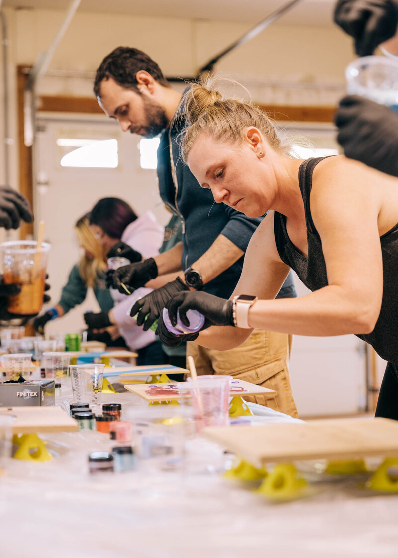 A group of women sit around a dining table smiling. 