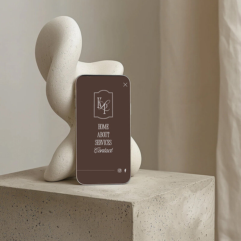 A phone on a table beside a sculpture, showcasing a modern aesthetic and mobile navigation feature.