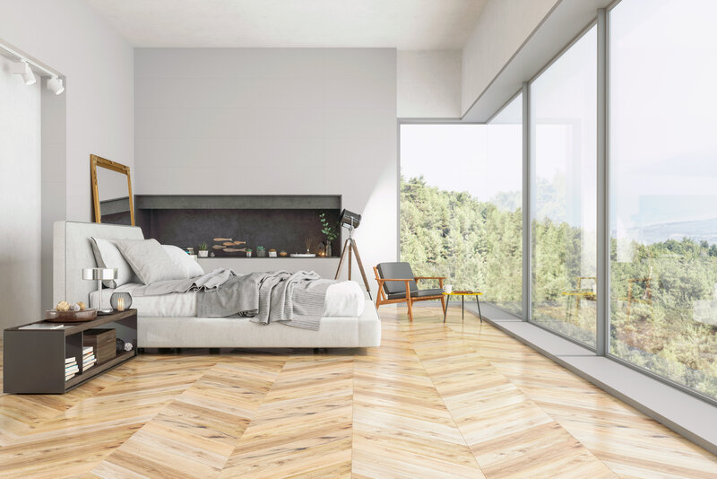 Modern bedroom with floor to ceiling windows looking out at nature