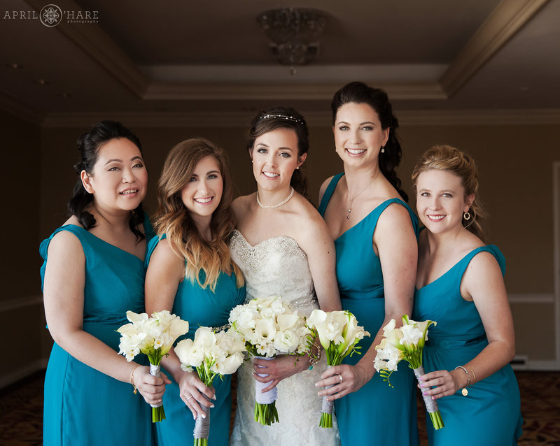Bride with her bridesmaids wearing teal at the Warwick Hotel in Denver