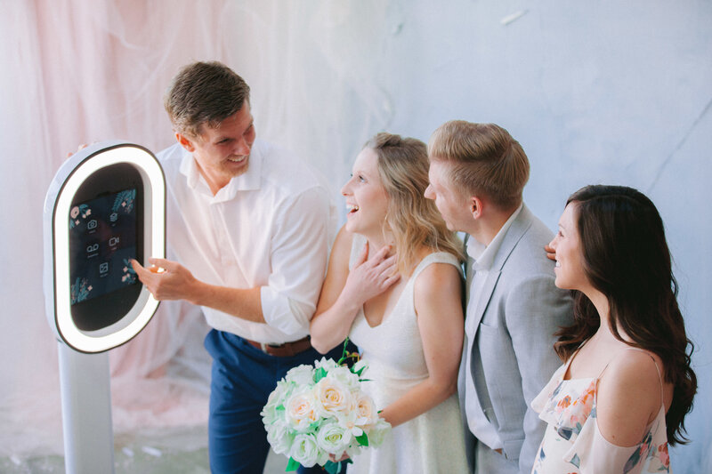 group of people taking photo booth pictures