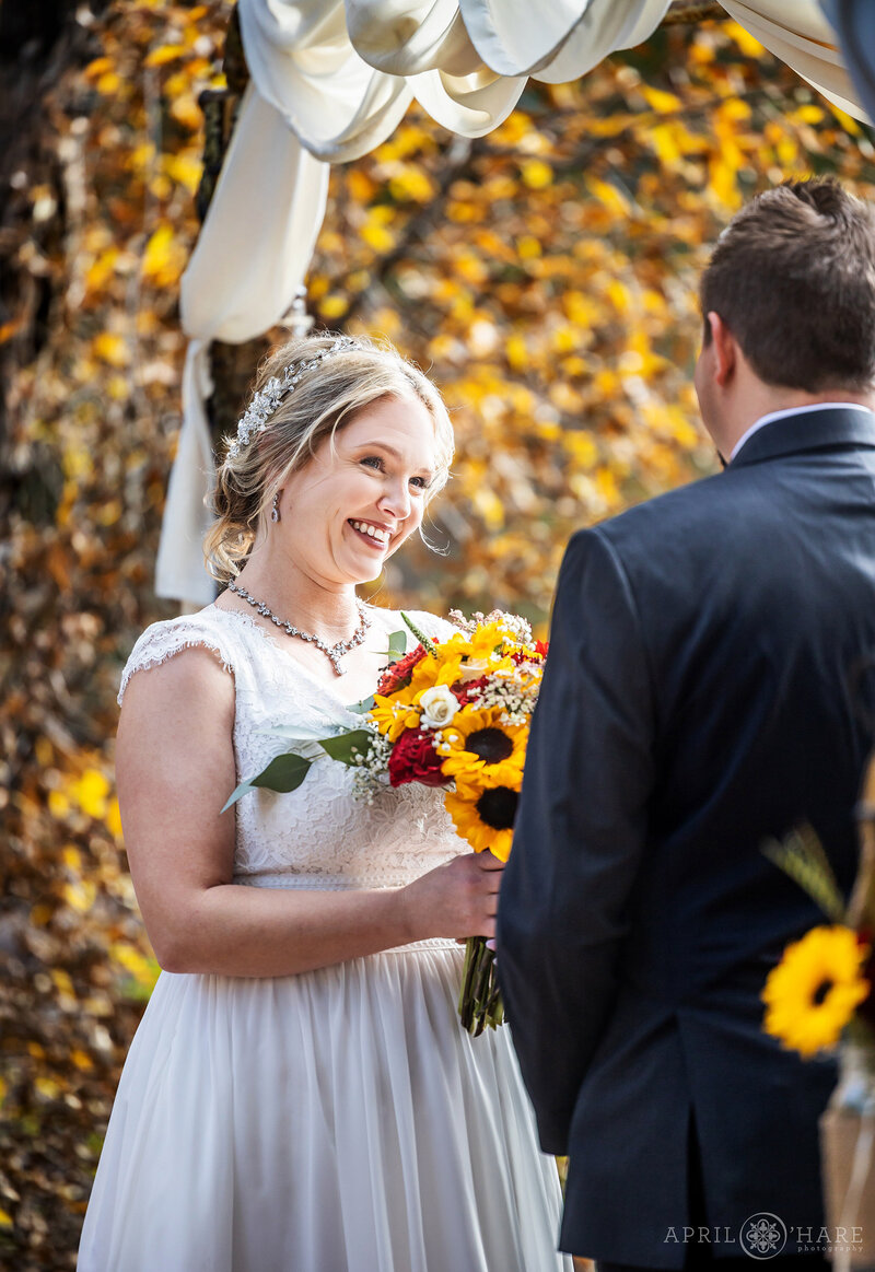 Bride Smiles at her Groom on their wedding day at Romantic Riversong Inn Estes Park CO