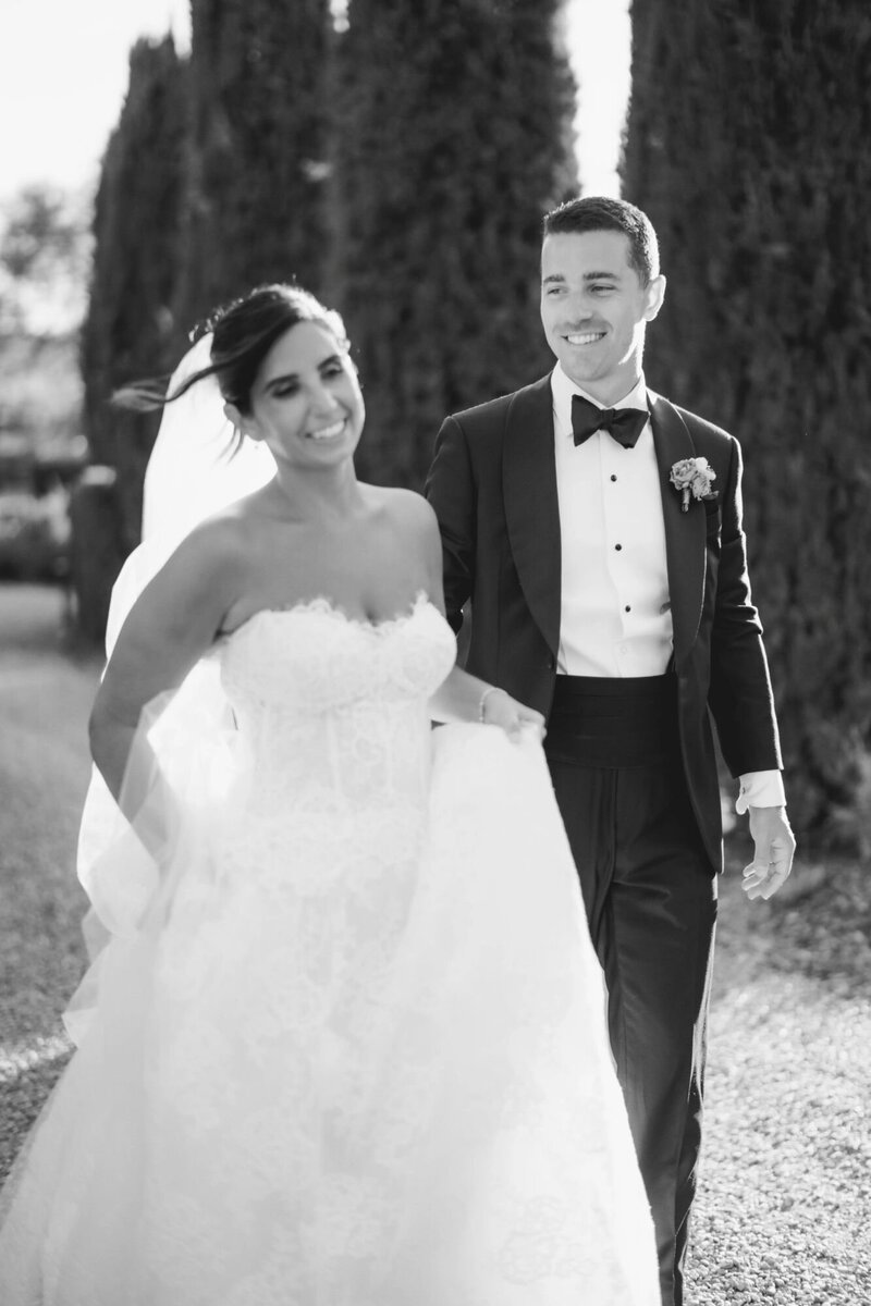  Bridal portrait during an Ombroneta wedding in Tuscany, with couple walking carelessly, by luxury destination wedding photographer Andreas K. Georgiou  