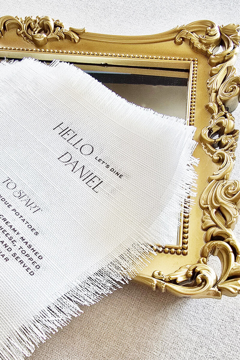 Custom linen wedding menu with fringe edges and personalized guest name, designed by Seventh and Anderson a Montana stationery design studio.