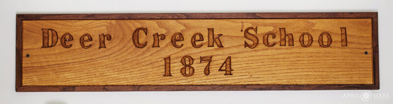 Wood sign for Deer Creek Schoolhouse 1874 historic  building at  Chatfield Farms
