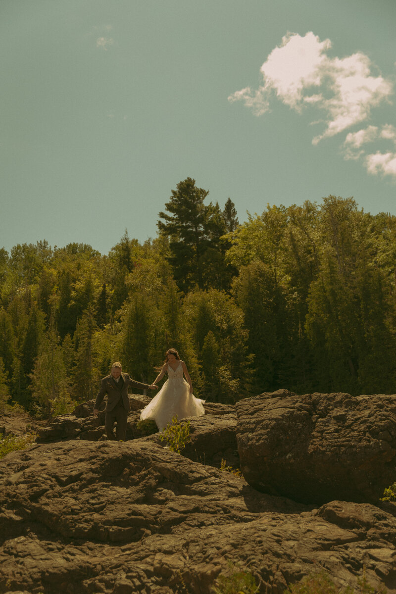 Man and woman romantically spin around, laughing in the middle of a  flowery field