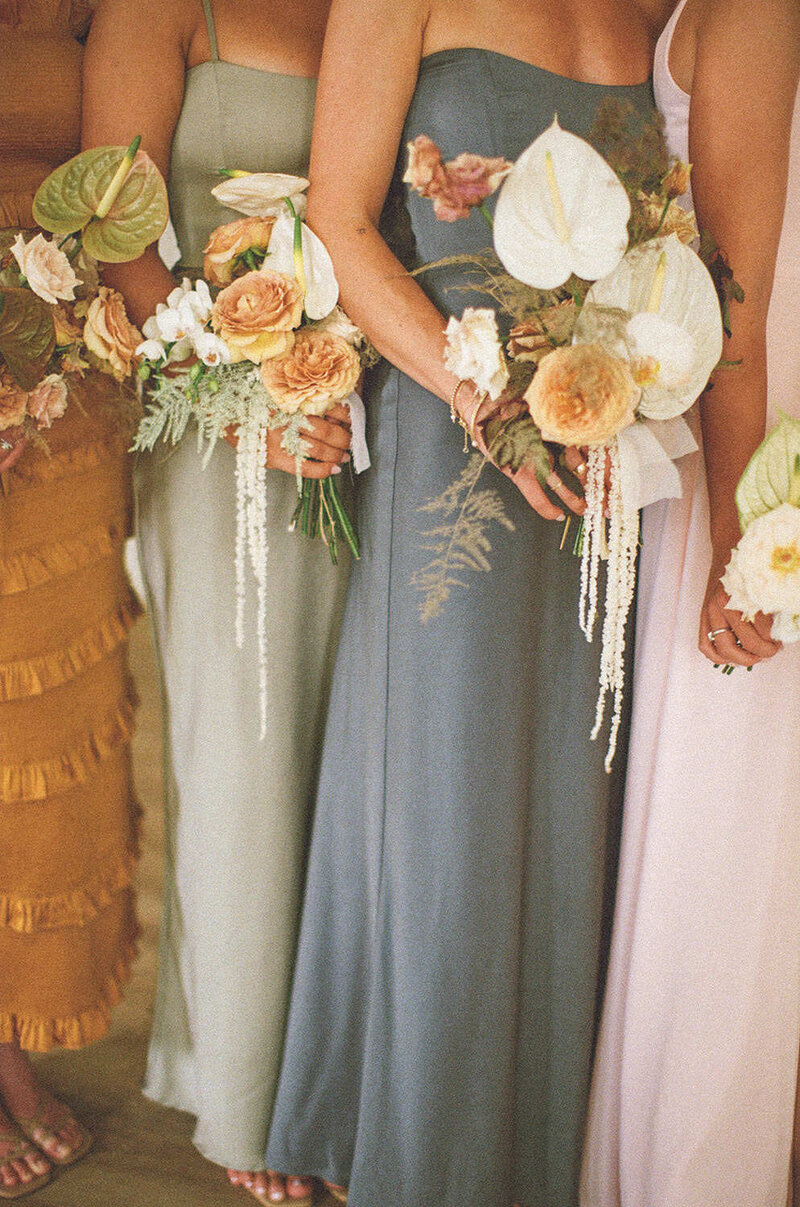 close up of bridesmaids holding exotic bouquet of flowers designed by Flower Treasures