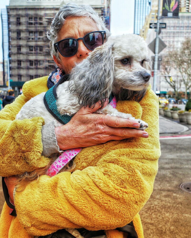 elderly woman holding her dog