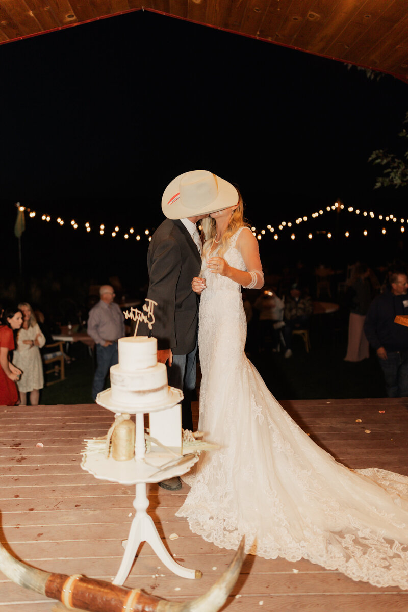 Cake smash wedding photo taken by Logan, Utah Wedding Photographer at a Western Wedding