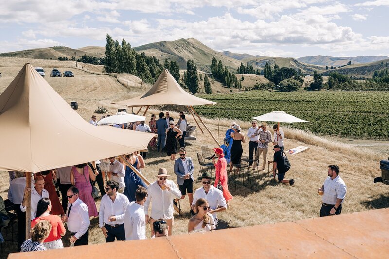 umbrellas set up at the boneline with base food by fire at a wedding in waipara