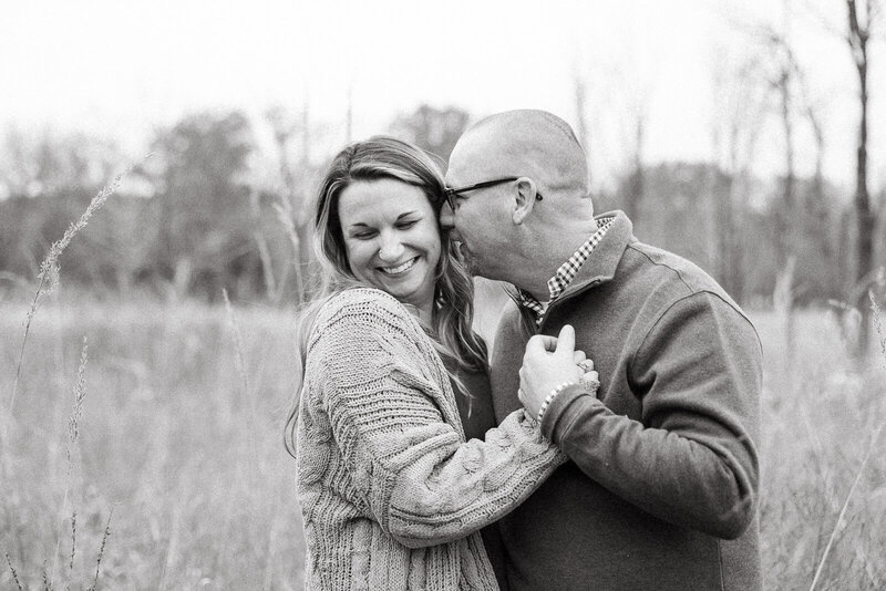 Husband kissing wife black and white portrait in a field in Bonne Terre, Missouri. 
