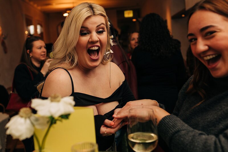 Friends toasting and celebrating during Dart Collective Chicago launch at Lou Lou by Lola Cafe