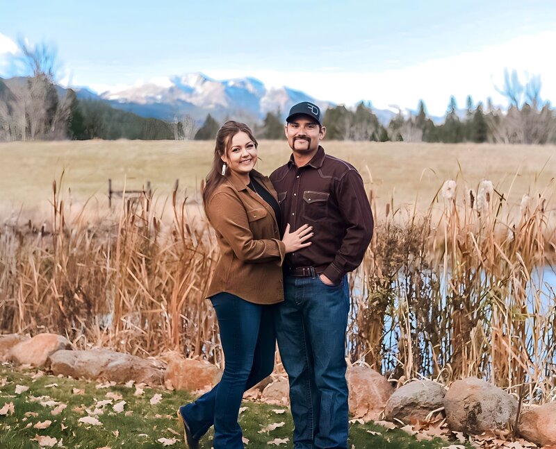 Hiliary and her partner Justin couple portrait with pond and mountain view in the background
