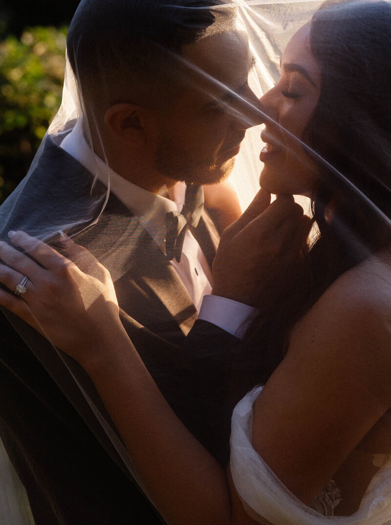 bride and groom kissing with confetti