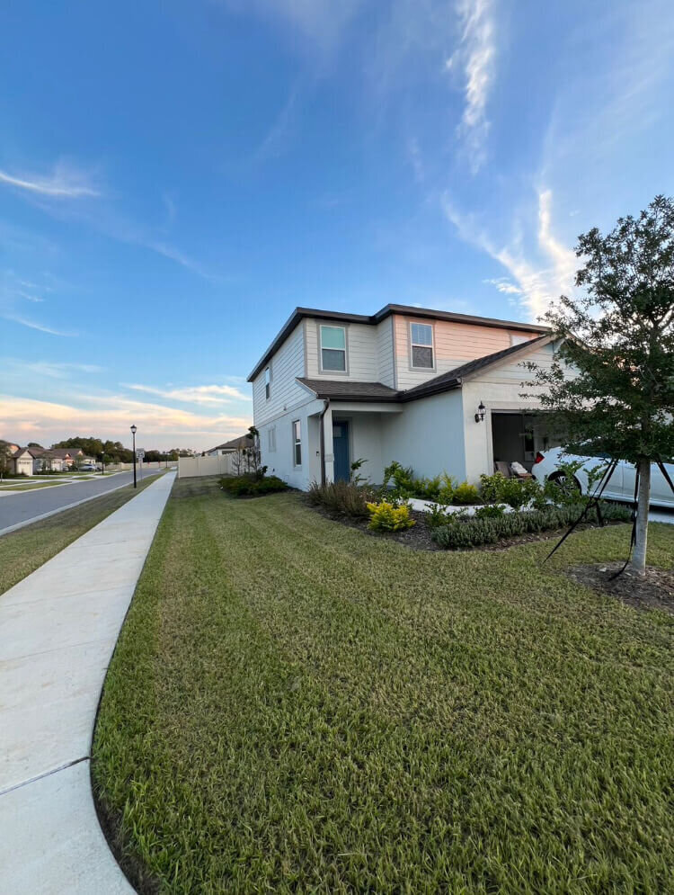 Freshly mowed lawn and edged pathway after routine maintenance in Polk County, FL