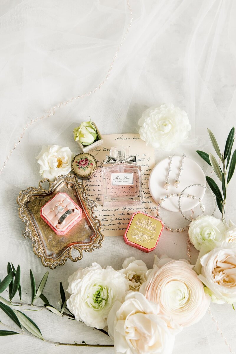 Flatlay with vintage tray, perfume, and florals