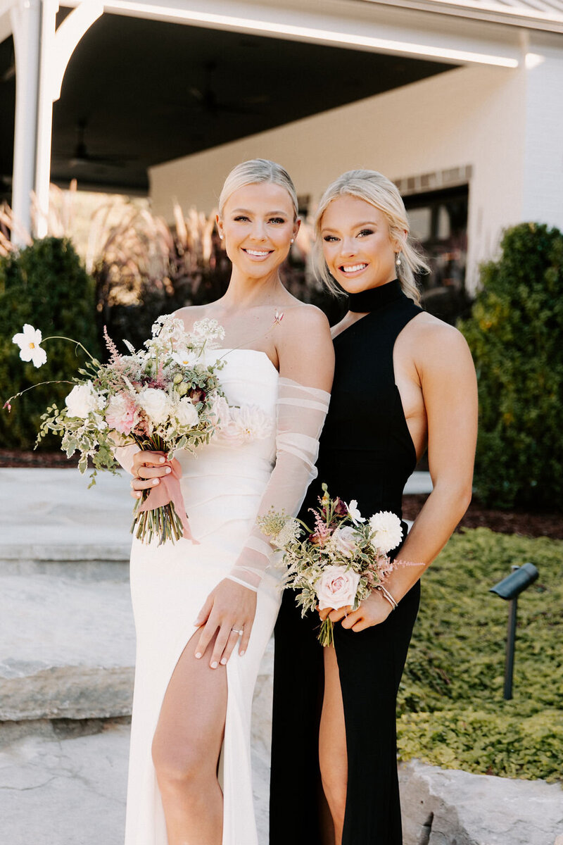 A Nashville bride and her maid of honor with wedding flowers