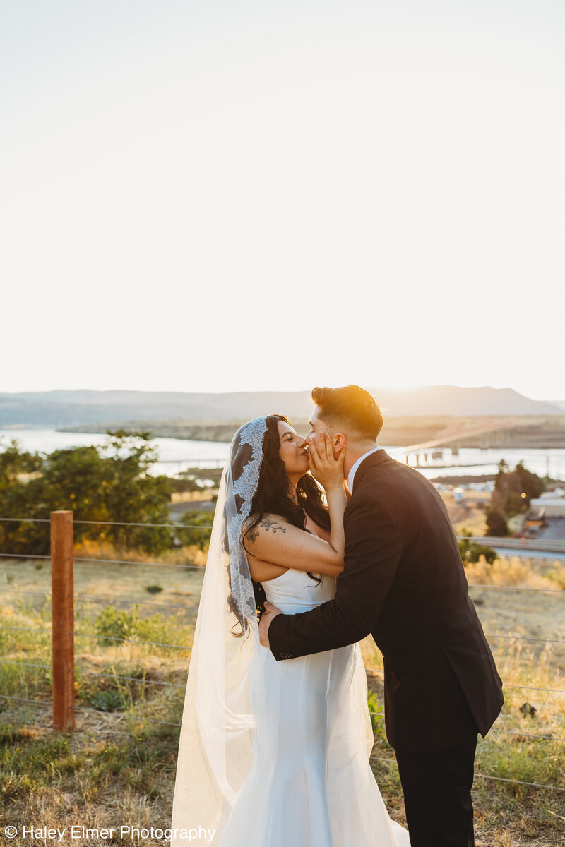 Groom with bride holding a bouquet