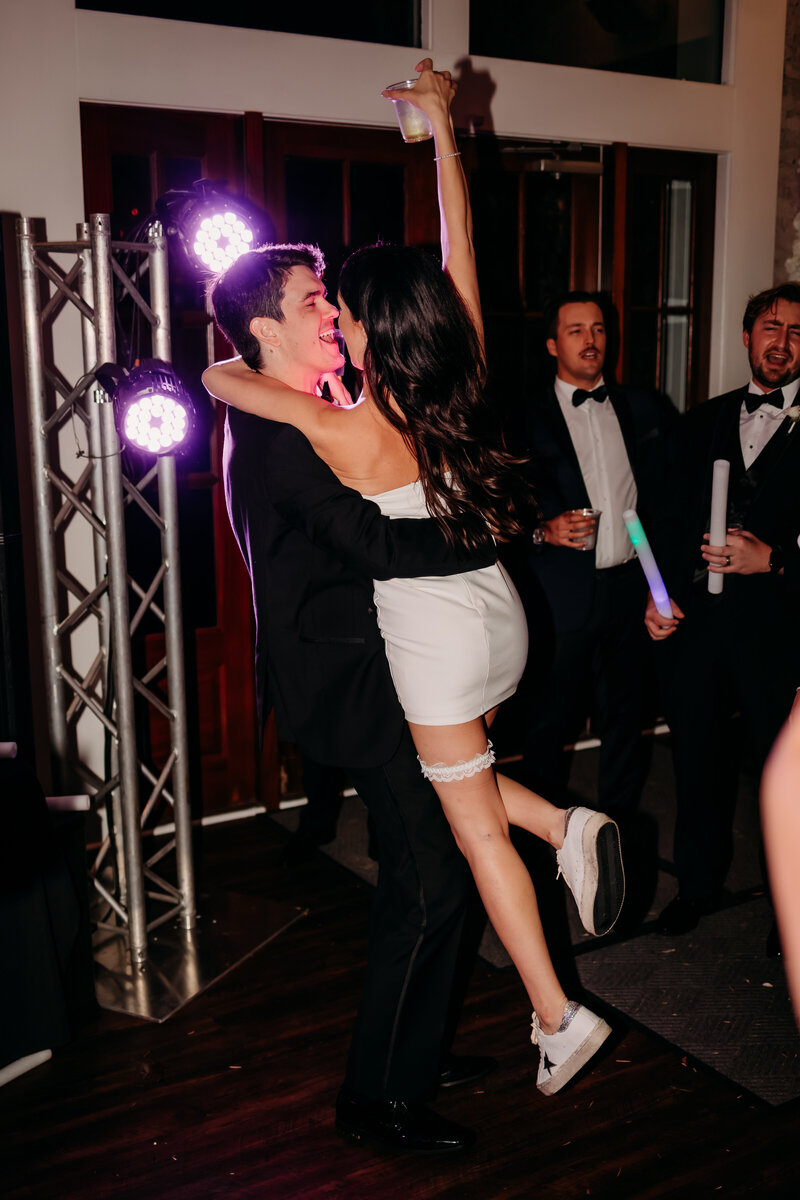 bride and groom spinning around dancing at their wedding reception