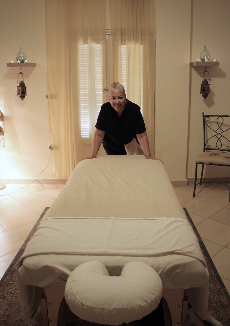 Massage therapist with her massage table