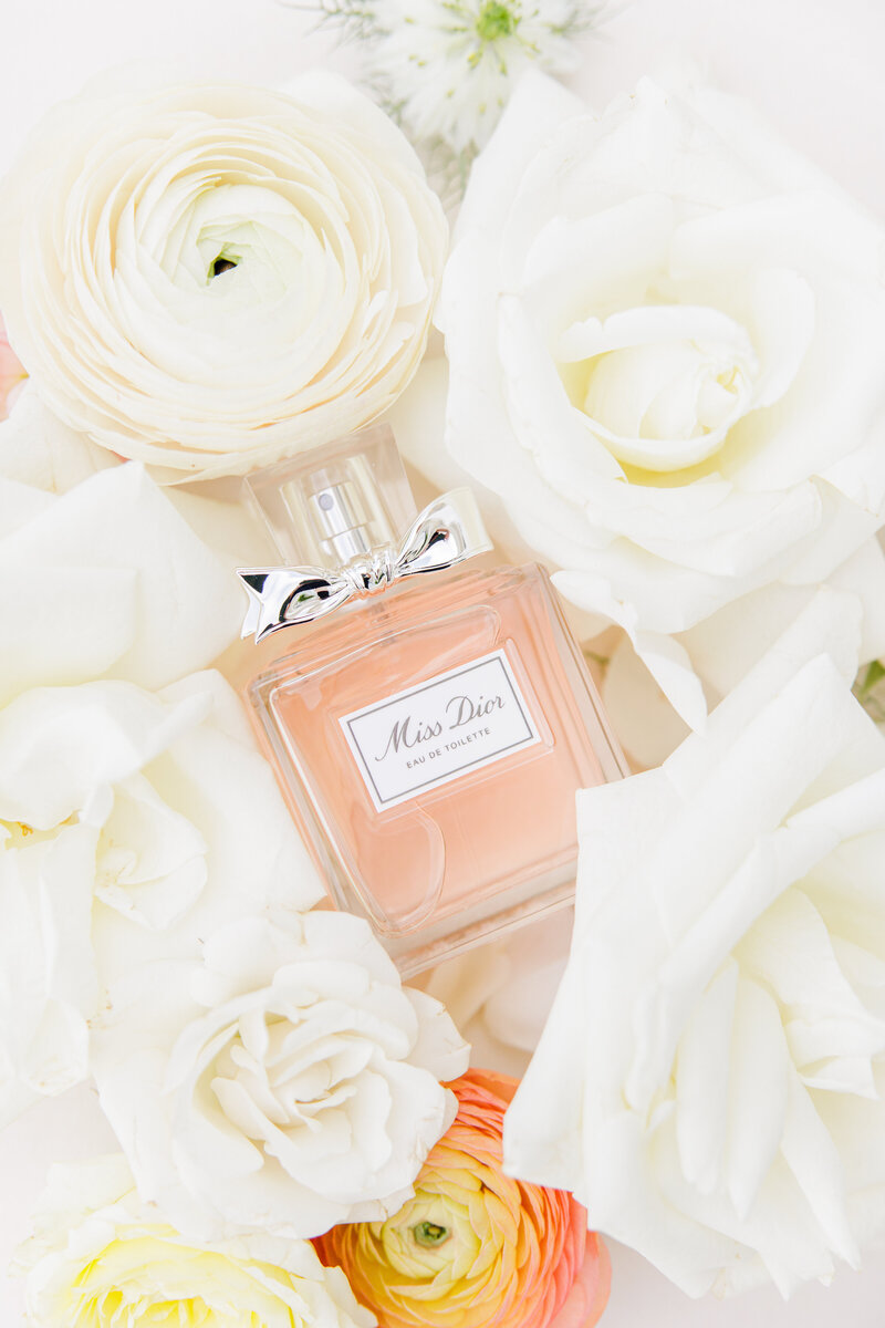Miss Dior perfume surrounded by florals