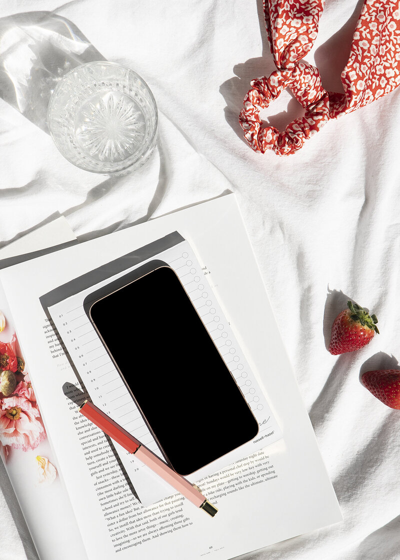 Phone and Pen On Dairy along with Strawberries