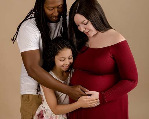 Beautiful new family expecting a baby, holding mom's tummy