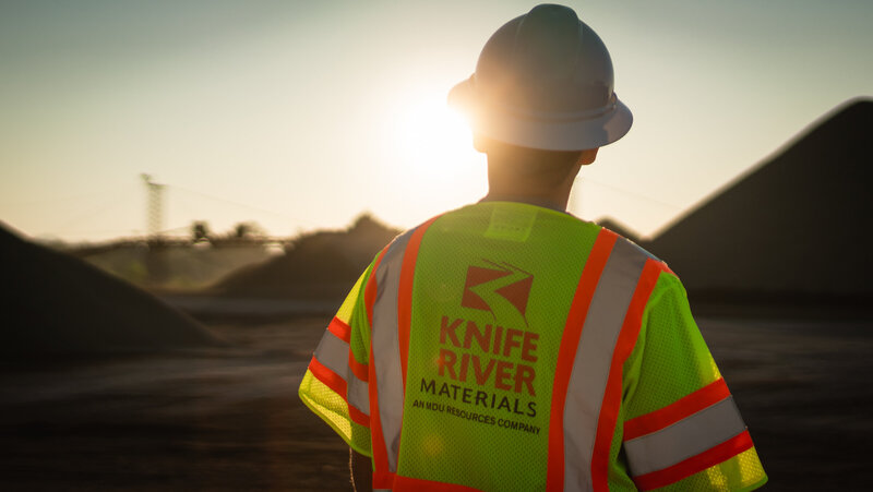 construction man looking at sunrise