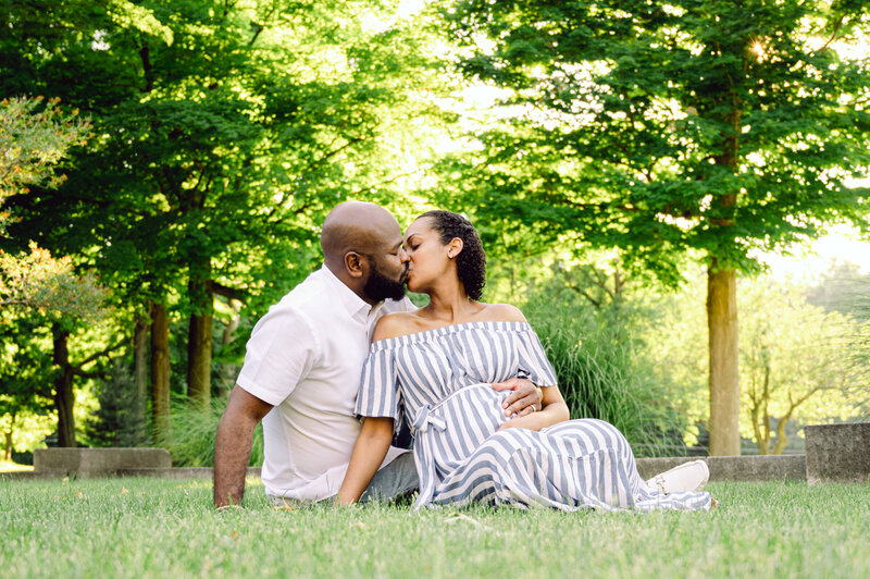 Outdoor maternity session of man andpregnant  woman in the park