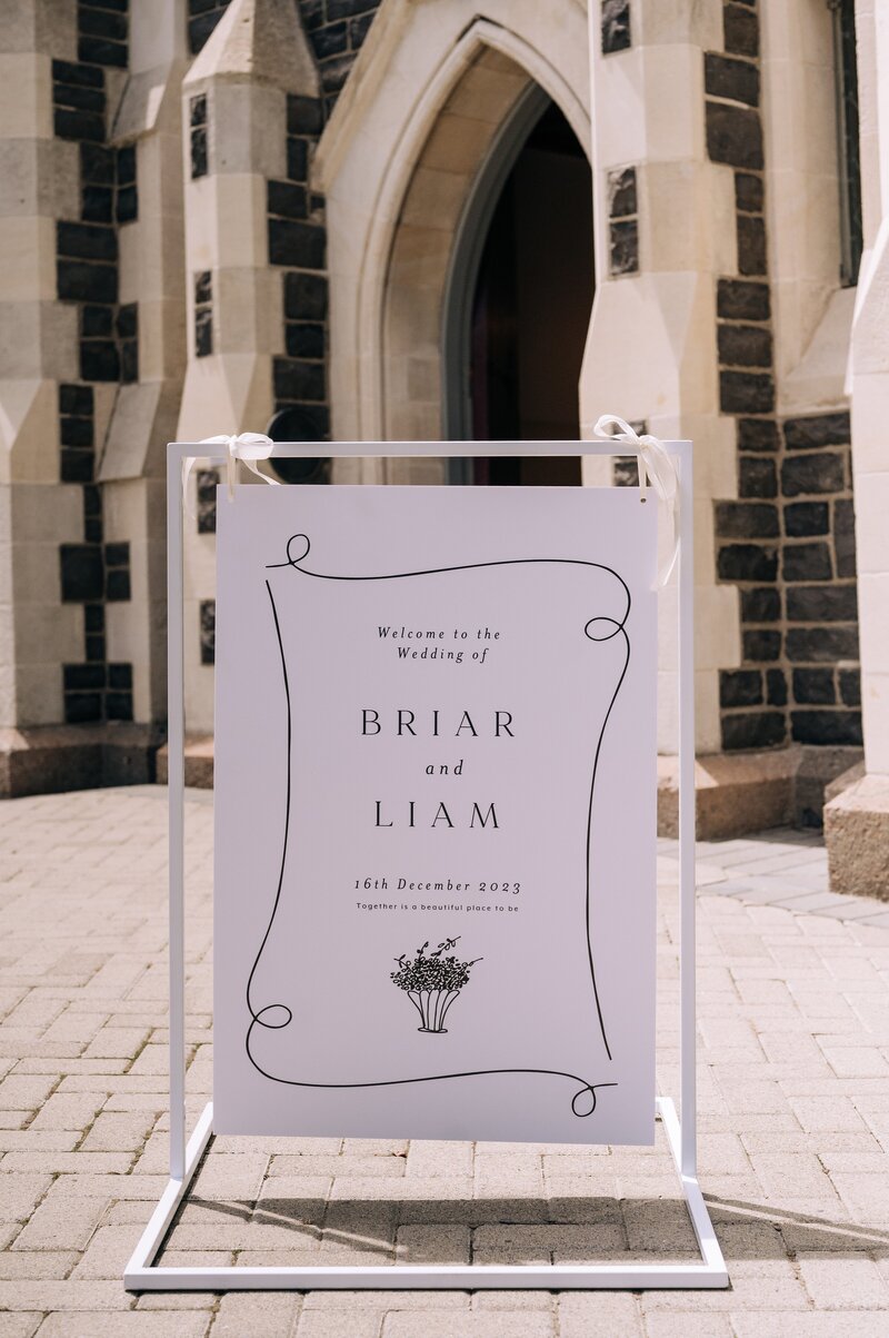 black and white minimalistic wedding sign outside the rose historic chapel wedding venue in christchurch