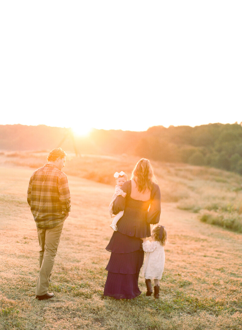 Family walks together at sunrise for a family session at the NC Museum of Art. Image by Raleigh family photographer A.J. Dunlap Photography