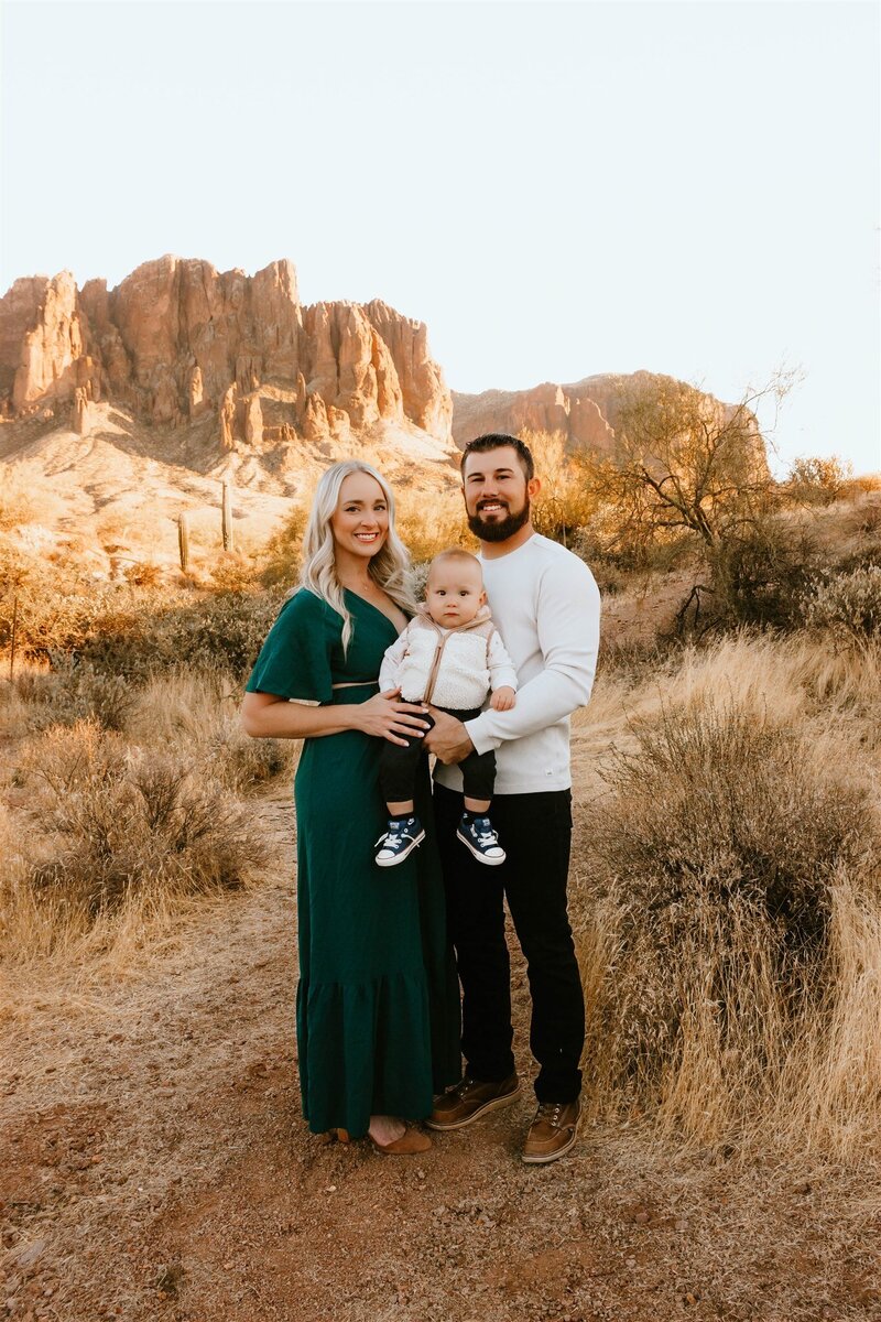 mom and dad holding son