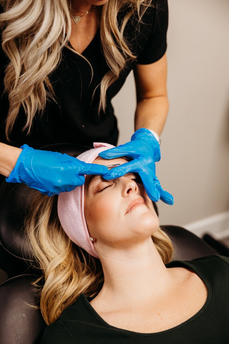 Esthetician giving woman a facial
